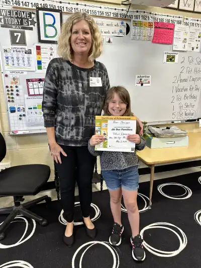 Image of a woman and a student holding a certificate